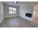 Bedroom featuring neutral paint, wood-look floors, and a fireplace at 1727 Butterfly Way, Longwood, FL 32750
