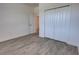 Bedroom featuring wood-look flooring and a closet, next to doorway with bathroom view at 1727 Butterfly Way, Longwood, FL 32750