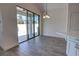 Bright dining area with sliding glass doors leading to patio, and elegant chandelier at 1727 Butterfly Way, Longwood, FL 32750
