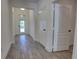 Bright Foyer has neutral paint, wood look flooring, and a front door with decorative glass at 1727 Butterfly Way, Longwood, FL 32750
