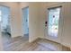 A welcoming foyer with decorative glass door and gray wood-look tile floors at 1727 Butterfly Way, Longwood, FL 32750