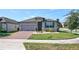 Charming single-story home featuring a well-maintained lawn and inviting brick driveway at 1727 Butterfly Way, Longwood, FL 32750