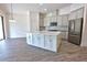 Modern kitchen featuring a center island, sleek stainless steel appliances, and ample counter space at 1727 Butterfly Way, Longwood, FL 32750