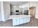 Elegant kitchen with an island, stainless steel appliances, and an open layout to living areas at 1727 Butterfly Way, Longwood, FL 32750