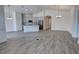 Open-concept kitchen featuring an island, modern appliances, and light wood-look flooring at 1727 Butterfly Way, Longwood, FL 32750