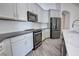 Modern kitchen featuring grey countertops, stainless steel appliances, and grey wash wood floors at 1727 Butterfly Way, Longwood, FL 32750