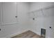 Small laundry room featuring wood-look floors, shelving, and utility hook-ups at 1727 Butterfly Way, Longwood, FL 32750