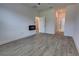 Living room with wood-look tile floors, fireplace, and doorways to other rooms at 1727 Butterfly Way, Longwood, FL 32750