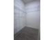 A walk-in closet with wood floor and metal shelving ready to organize all your belongings at 1727 Butterfly Way, Longwood, FL 32750