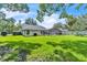 Expansive backyard with lush green lawn, screened-in pool, and ample privacy at 1745 Seneca Blvd, Winter Springs, FL 32708