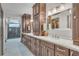 Well-lit bathroom with double vanity sinks and marble countertops, and custom cabinetry at 1745 Seneca Blvd, Winter Springs, FL 32708