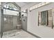 Modern bathroom with a glass shower, marble bench and a heated towel rack at 1745 Seneca Blvd, Winter Springs, FL 32708
