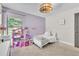 Cozy bedroom features a plush bed, whimsical decor and natural light from the window at 1745 Seneca Blvd, Winter Springs, FL 32708