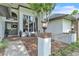 Inviting front porch with mature landscaping and walkway at 1745 Seneca Blvd, Winter Springs, FL 32708