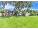 Charming home features a spacious front yard, stucco exterior, and mature landscaping at 1745 Seneca Blvd, Winter Springs, FL 32708