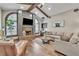 Inviting living room features a brick fireplace, vaulted ceilings with exposed beams, and ample seating at 1745 Seneca Blvd, Winter Springs, FL 32708