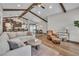 Expansive living room with wooden beams, neutral color palette, and easy access to kitchen and dining area at 1745 Seneca Blvd, Winter Springs, FL 32708