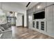 Inviting living room featuring custom built-ins, modern lighting and hard wood floors at 1745 Seneca Blvd, Winter Springs, FL 32708