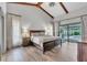 Bright and airy main bedroom with exposed beams and a view to the pool at 1745 Seneca Blvd, Winter Springs, FL 32708