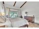 Bright main bedroom with vaulted ceilings, exposed beams, and backyard pool view at 1745 Seneca Blvd, Winter Springs, FL 32708