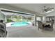 Inviting screened-in pool area with an outdoor dining set and lounge area at 1745 Seneca Blvd, Winter Springs, FL 32708