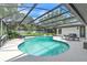 Beautiful screened-in pool with a seating and dining area, perfect for outdoor entertainment at 1745 Seneca Blvd, Winter Springs, FL 32708