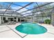 Beautiful screened-in pool area with a dining area and comfortable lounge seating at 1745 Seneca Blvd, Winter Springs, FL 32708