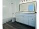 Bathroom featuring double vanity, granite countertops, and modern fixtures, complemented by gray floors and a shower-tub combo at 215 Hollowbrook Cir, Daytona Beach, FL 32114