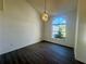 Bedroom with gray floors, large window, and modern light fixture to create a cozy ambiance at 215 Hollowbrook Cir, Daytona Beach, FL 32114