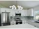 Modern kitchen featuring stainless steel appliances, stylish backsplash, and a contemporary light fixture at 215 Hollowbrook Cir, Daytona Beach, FL 32114