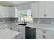 Bright and updated kitchen featuring quartz countertops, stainless steel appliances, and gray subway tile backsplash at 215 Hollowbrook Cir, Daytona Beach, FL 32114