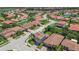Aerial view of a neighborhood with houses featuring tile roofs and well-maintained landscaping at 2325 Bella Luna Cir, Lakeland, FL 33810