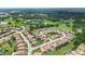 Aerial shot of residential area with houses and beautiful green spaces and pond in the background at 2325 Bella Luna Cir, Lakeland, FL 33810