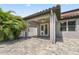 A shaded back patio featuring a ceiling fan, decorative pavers, and a view of the manicured yard at 2325 Bella Luna Cir, Lakeland, FL 33810