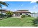 Wide view of a backyard featuring a paver patio, well-maintained lawn, and privacy fence at 2325 Bella Luna Cir, Lakeland, FL 33810
