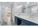 Bathroom with double sinks, vanity with storage, mirrors, and open door to adjacent room at 2325 Bella Luna Cir, Lakeland, FL 33810