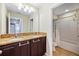 Bathroom with double vanity, granite counters, and a shower/tub combo at 2325 Bella Luna Cir, Lakeland, FL 33810