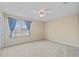 Bright bedroom with large window, ceiling fan, and neutral carpet at 2325 Bella Luna Cir, Lakeland, FL 33810