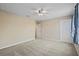 Bright bedroom features neutral walls, plush carpet, and a modern ceiling fan at 2325 Bella Luna Cir, Lakeland, FL 33810