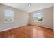Light-filled bedroom featuring wood floors and two large windows with neutral walls creating a bright, airy feel at 2325 Bella Luna Cir, Lakeland, FL 33810