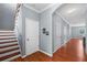 Hallway view featuring hardwood floors, white doors, and stairs leading to the second floor at 2325 Bella Luna Cir, Lakeland, FL 33810