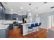 Bright kitchen with stainless steel appliances, white subway tile backsplash, and dark blue cabinets with bar seating at 2325 Bella Luna Cir, Lakeland, FL 33810