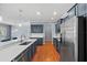 Modern kitchen featuring stone countertops, stainless steel appliances, and hardwood floors at 2325 Bella Luna Cir, Lakeland, FL 33810