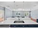 Modern kitchen featuring a large island with a stainless steel sink, quartz countertops, and stylish blue cabinetry at 2325 Bella Luna Cir, Lakeland, FL 33810
