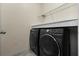 Laundry room with side-by-side washer and dryer, plus wire rack storage at 2325 Bella Luna Cir, Lakeland, FL 33810