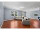 Spacious living room with wood floors, a large sectional sofa, and bright natural light from windows and doors at 2325 Bella Luna Cir, Lakeland, FL 33810