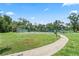 Outdoor tennis court with green surroundings, perfect for recreational games and fitness activities at 2325 Bella Luna Cir, Lakeland, FL 33810