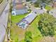 Aerial view of backyard featuring a large pool with a screen enclosure, green grass, and tree line at 2627 Autumn Creek Cir, Kissimmee, FL 34747