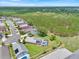 Expansive aerial view of a neighborhood featuring a home with a unique screened-in pool area at 2627 Autumn Creek Cir, Kissimmee, FL 34747