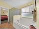 Bright bathroom with a glass-enclosed shower and relaxing soaking tub at 2627 Autumn Creek Cir, Kissimmee, FL 34747